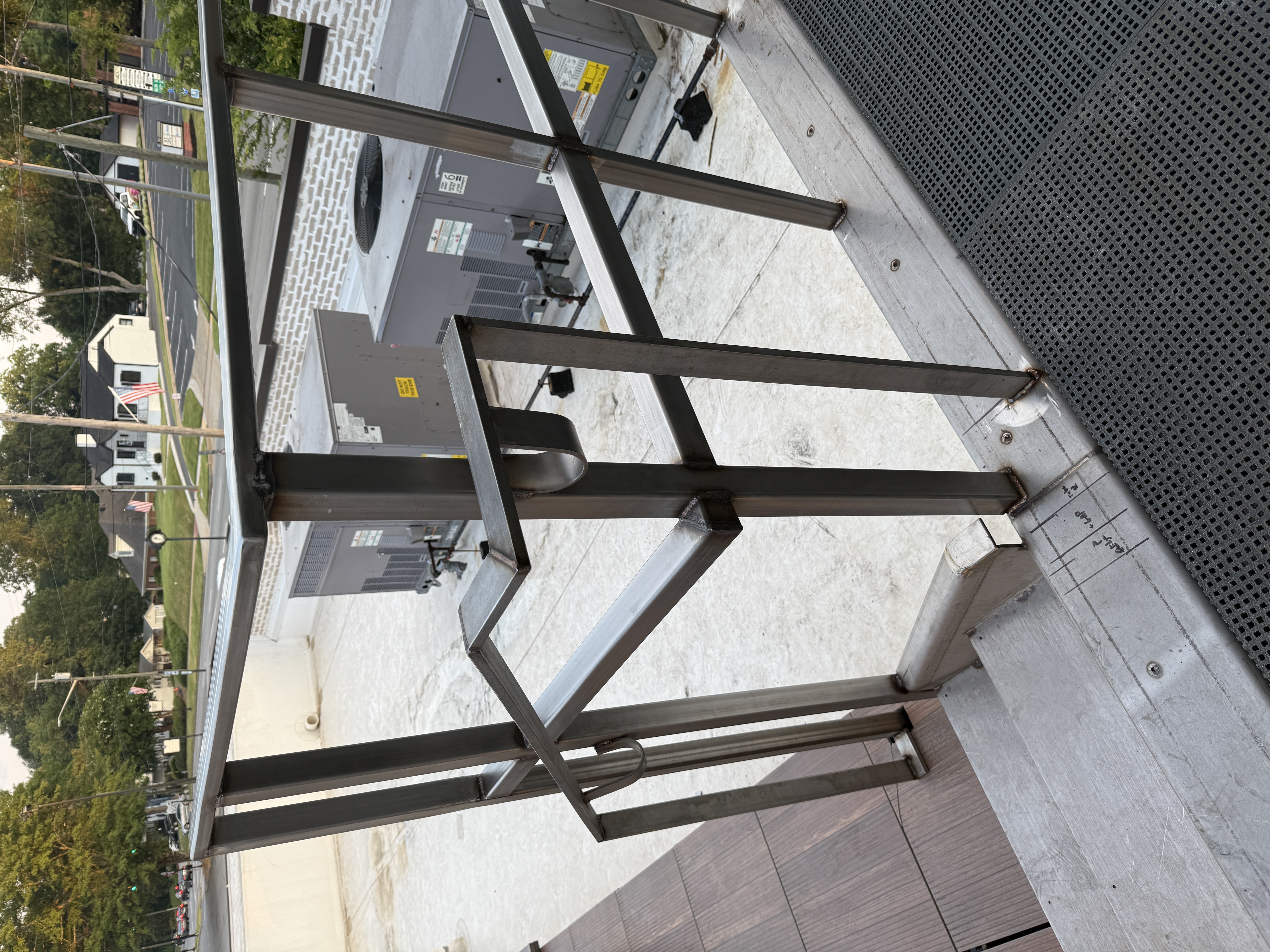 Custom steel and glass architectural feature with stone courtyard