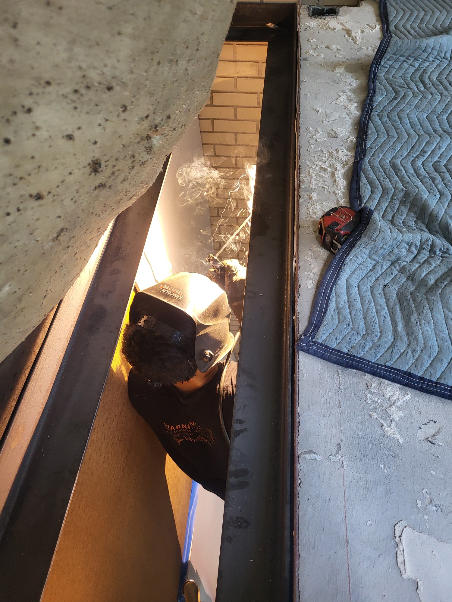 Fabricator welding with oxy-acetylene torch